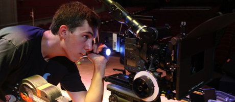 Robert looking at a video camera with a flashlight